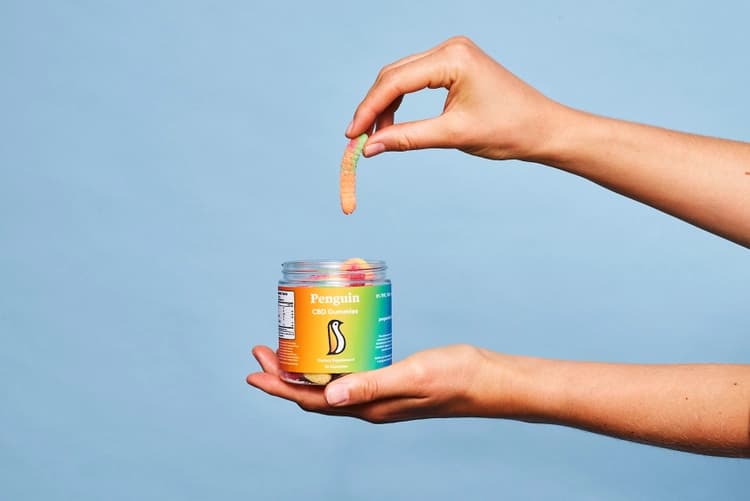 hand holding a gummy worm