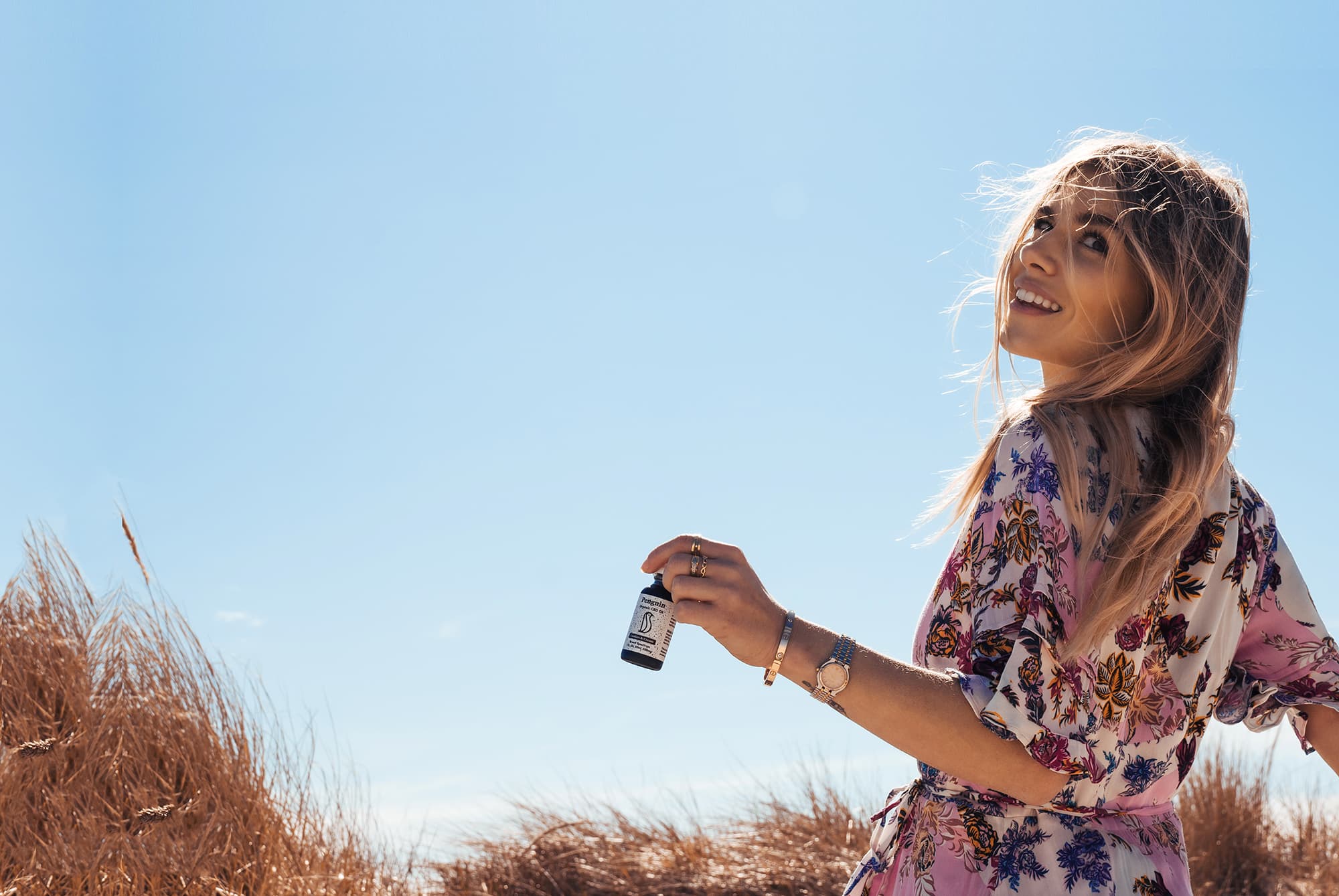 Woman holding CBD tincture bottle